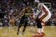 Indiana Pacers' Paul George (24) drives to the basket as Miami Heat's LeBron James defends during the first half of an NBA basketball game, Friday, April 11, 2014, in Miami. (AP Photo/Lynne Sladky)