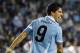 Uruguay's Luis Suarez celebrates after scoring his team's first goal during a Copa America semifinal soccer match against Peru in La Plata, Argentina, Tuesday, July 19, 2011. On top, an Uruguayan flag. (AP Photo/Natacha Pisarenko)