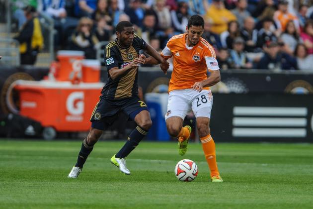 Apr 19, 2014; Chester, PA, USA; Philadelphia Union defender Raymon Gaddis (28) and Houston Dynamo midfielder Tony Cascio (28) battle for a ball during the first half of the game at PPL Park. The game ended in a 0-0 draw. Mandatory Credit: John Geliebter-USA TODAY Sports