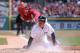 DETROIT, MI - APRIL 20: Ian Kinsler #3 of the Detroit Tigers slides home and beats the tag of catcher Hank Conger #16 on a throwing error during the first inning of the game against the Los Angeles Angels of Anaheim at Comerica Park on April 20, 2014 in Detroit, Michigan. (Photo by Leon Halip/Getty Images)