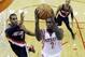Houston Rockets' Patrick Beverley shoots past Portland Trail Blazers' LaMarcus Aldridge (12) and Damian Lillard during the first half in Game 1 of an opening-round NBA basketball playoff series, Sunday, April 20, 2014, in Houston. (AP Photo/David J. Phillip)
