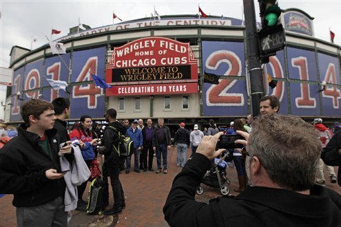 Chicago Tribune - Fans gather near the Wrigley Field marquee on