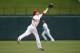 Texas Rangers shortstop Josh Wilson catches a ball hit by Houston Astros' L.J. Hoes for the out during the fifth inning of a baseball game, Sunday, April 13, 2014, in Arlington, Texas. (AP Photo/Jim Cowsert)