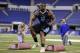 Minnesota defensive lineman Ra'Shede Hageman runs a drill at the NFL football scouting combine in Indianapolis, Monday, Feb. 24, 2014. (AP Photo/Michael Conroy)