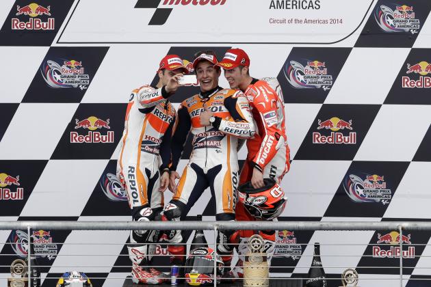 Dani Pedrosa, from left, of Spain, Marc Marquez of Spain, and Andrea Dovizioso, right, of Italy shoot a selfie of themselves on the winners podium following the Grand Prix of the Americas MotoGP motorcycle race, Sunday, April 13, 2014, in Austin, Texas. Marquez won the race, with Pedrosa and Dovizioso in second and third respectively. (AP Photo/Tony Gutierrez)