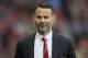 Manchester United's interim manager Ryan Giggs smiles as he takes to the touchline before his team's English Premier League soccer match against Norwich City at Old Trafford Stadium, Manchester, England, Saturday April 26, 2014. (AP Photo/Jon Super)