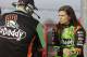 Danica Patrick, right, talks to a crew member before qualifying for a NASCAR Sprint Cup series auto race at Darlington Speedway in Darlington, S.C., Friday, April 11, 2014. (AP Photo/Chuck Burton)