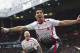 Liverpool's Luis Suarez celebrates after scoring against Manchester United, during their English Premier League soccer match at Old Trafford Stadium, Manchester, England, Sunday, March 16, 2014. (AP Photo/Jon Super)