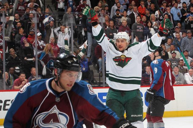 DENVER, CO - APRIL 30:  Nino Niederreiter #22 of the Minnesota Wild celebrates his overtime, series-winning goal as Erik Johnson #6 of the Colorado Avalanche reacts in Game Seven of the First Round of the 2014 Stanley Cup Playoffs at the Pepsi Center on April 30, 2014 in Denver, Colorado.  The Wild defeated the Avalanche in overtime 5-4.  (Photo by Michael Martin/NHLI via Getty Images)