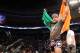 Conor McGregor, of Ireland, leaves the ring draped in an Irish flag after beathing Max Holloway in their UFC on Fox Sports 1 mixed martial arts bout in Boston, Saturday, August 17,2013. McGregor won via unanimous decision. (AP Photo/Gregory Payan)