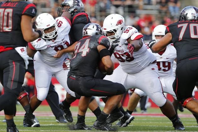 Sep 21, 2013; Piscataway, NJ, USA;  Arkansas Razorbacks defensive tackle Darius Philon (91) and defensive tackle DeMarcus Hodge (93) corral Rutgers Scarlet Knights running back Paul James (34) for no gain during the first half at High Points Solutions Stadium. Mandatory Credit: Jim O'Connor-USA TODAY Sports