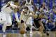 Dallas Mavericks' Shawn Marion, left, and Jose Calderon, center, of Spain, chase after the ball against San Antonio Spurs' Tony Parker, right, of France, in the first half of Game 6 of an NBA basketball first-round playoff series on Friday, May 2, 2014, in Dallas. (AP Photo/Tony Gutierrez)