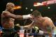 LAS VEGAS, NV - MAY 03: (L-R) Floyd Mayweather Jr. and Marcos Maidana exchange blows during their WBC/WBA welterweight unification fight at the MGM Grand Garden Arena on May 3, 2014 in Las Vegas, Nevada. (Photo by Harry How/Getty Images)