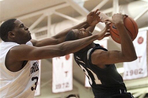 Fordham's Ryan Rhoomes, left, fouls Butler's Kameron Woods the second half of an NCAA college basketball game, Saturday, Feb. 16, 2013 in New York. Butler won 68-63. (AP Photo/Mary Altaffer)
