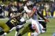 Ohio State's Dontre Wilson (1) is stopped by Michigan' Dennis Norfleet (23) on a punt return during the second quarter of an NCAA college football game in Ann Arbor, Mich., Saturday, Nov. 30, 2013. (AP Photo/Carlos Osorio)