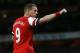 Arsenal's Lukas Podolski celebrates scoring a goal during the English Premier League soccer match between Arsenal and West Ham United at the Emirates stadium in London, Tuesday, April 15, 2014. (AP Photo/Kirsty Wigglesworth)