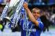 LONDON, ENGLAND - MAY 09: Ashley Cole of Chelsea celebrates with the trophy as they win the title after the Barclays Premier League match between Chelsea and Wigan Athletic at Stamford Bridge on May 9, 2010 in London, England. Chelsea won 8-0 to win the championship. (Photo by Shaun Botterill/Getty Images)