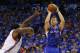 Los Angeles Clippers forward Blake Griffin,right, shoots over Oklahoma City Thunder center Kendrick Perkins, left, in the first quarter of Game 1 of the Western Conference semifinal NBA basketball playoff series in Oklahoma City, Monday, May 5, 2014. (AP Photo/Sue Ogrocki)