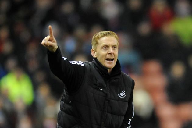 Swansea City manager Garry Monk gesticulates from the sideline during the English Premier League soccer match between Stoke City and Swansea City at Britannia Stadium in Stoke on Trent, England, Wednesday, Feb. 12, 2014.  (AP Photo/Rui Vieira)