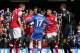Arsenal's Kieran Gibbs, second right,along with teammate Alex Oxlade-Chamberlain, second left, question the referee Andre Marriner, in grey, after being shown a red card during their English Premier League soccer match between Chelsea and Arsenal at Stamford Bridge stadium in London Saturday, March 22 2014. Although Alex Oxlade-Chamberlain blatantly handled to keep out Eden Hazard's shot, it was Kieran Gibbs who was dismissed despite his teammate's protests. Hazard scored Chelsea's third from the resulting penalty.(AP Photo/Alastair Grant)