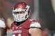 Arkansas center Travis Swanson walks onto the field before an NCAA college football game against South Carolina in Fayetteville, Ark., Saturday, Oct. 12, 2013. (AP Photo/David Quinn)