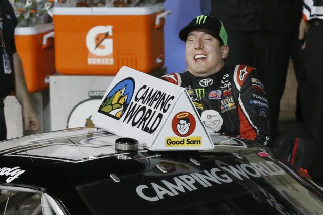 Kyle Busch slips as he climbs out of his car after winning the NASCAR Camping World Truck Series race at Kansas Speedway in Kansas City, Kan., Friday, May 9, 2014. (AP Photo/Orlin Wagner)