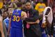 Golden State Warriors head coach Mark Jackson, center, hugs guard Stephen Curry after Curry was taken out of the game as forward Draymond Green looks on during the second half in Game 7 of an opening-round NBA basketball playoff series, Saturday, May 3, 2014, in Los Angeles. The Clippers won 126-121. (AP Photo/Mark J. Terrill)