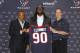 HOUSTON, TX - MAY 09: Jadeveon Clowney (C) displays his Houston Texans jersey with general manager Rick Smith (L) and Houston Texans head coach Bill O'Brien (R) at Reliant Stadium on May 9, 2014 in Houston, Texas. Clowney was selected by the Texans with the first overall pick in the 2014 NFL draft. (Photo by Bob Levey/Getty Images)