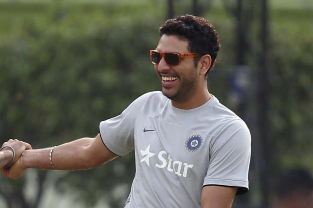 India's Yuvraj Singh, second left, shares a light moment with teammates during a training session ahead of their ICC Twenty20 Cricket World Cup final match against Sri Lanka in Dhaka, Bangladesh, Saturday, April 5, 2014. (AP Photo/Aijaz Rahi)
