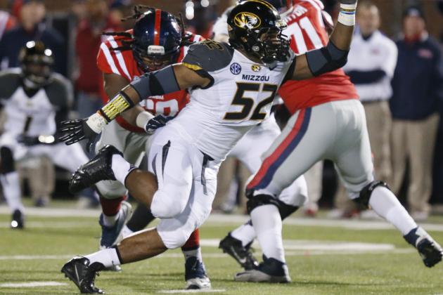 FILE - In this Nov. 23, 2013, file photo, Missouri defensive lineman Michael Sam (52) pushes past a block by Mississippi offensive linesman Pierce Burton (71) during the second half of an NCAA college football game in Oxford, Miss. Sam was selected in the seventh round, 249th overall, by the St. Louis Rams in the NFL draft Saturday, May 10, 2014. The Southeastern Conference defensive player of the year last season for Missouri came out as gay in media interviews this year. (AP Photo/Rogelio V. Solis, File)