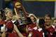 Oklahoma's Keilani Ricketts, left, holds the championship trophy after Oklahoma defeated Tennessee in the second game of the best of three Women's College World Series NCAA softball championship series in Oklahoma City, Tuesday, June 4, 2013. Oklahoma won the game 4-0 and the best of three series in two games.(AP Photo/Sue Ogrocki)