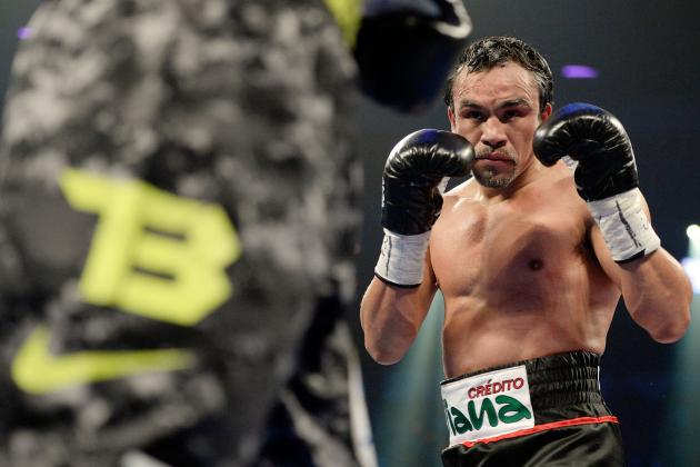 LAS VEGAS, NV - OCTOBER 12: Juan Manuel Marquez (R) looks to strike WBO welterweight champion Timothy Bradley Jr. during their bout at the Thomas & Mack Center on October 12, 2013 in Las Vegas, Nevada. Timothy Bradley Jr. wins in a split-decision victory over Juan Manuel Marquez. (Photo by Jeff Bottari/Getty Images)