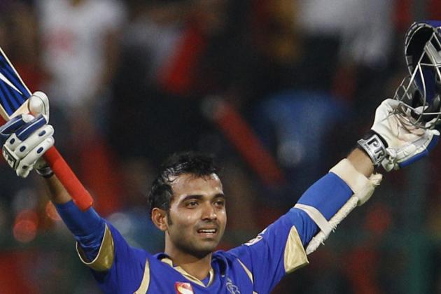 Rajasthan Royals batsman Ajinkya Rahane raises his bat and helmet to celebrate scoring a century during their Indian Premier League (IPL) cricket match against Royal Challengers Bangalore in Bangalore, India, Sunday, April 15, 2012. (AP Photo/Aijaz Rahi)