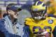 Michigan offensive coordinator Doug Nussmeier, left, laughs with quarterback Devin Gardner (98) during the NCAA college football team's annual spring game on Saturday, April 5, 2014, in Ann Arbor, Mich. (AP Photo/Tony Ding)