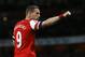Arsenal's Lukas Podolski celebrates scoring a goal during the English Premier League soccer match between Arsenal and West Ham United at the Emirates stadium in London, Tuesday, April 15, 2014. (AP Photo/Kirsty Wigglesworth)
