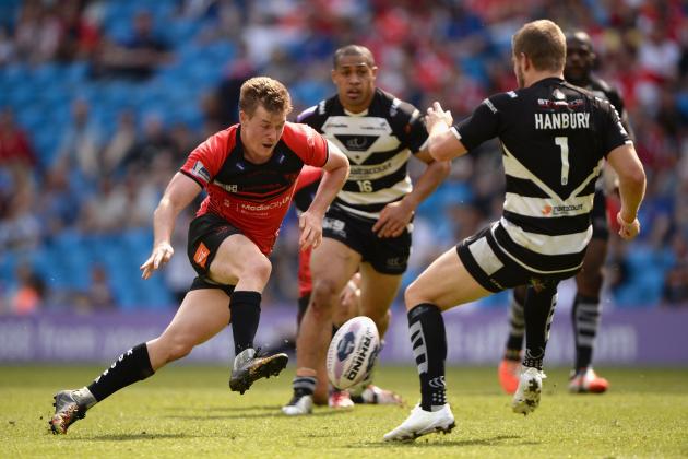 MANCHESTER, ENGLAND - MAY 17: Jake Mullaney of Salford Red Devils kicks past Rhys Hanbury of Widnes Vikings during the Super League match between Widnes Vikings and Salford Red Devils at Etihad Stadium on May 17, 2014 in Manchester, England. (Photo by Gareth Copley/Getty Images)