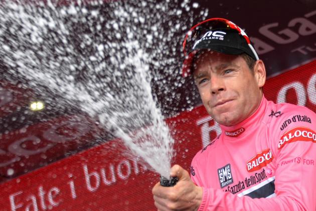 Cadel Evans celebrates on the podium after completing the 9th stage of the Giro d'Italia, Tour of Italy cycling race, from Lugo to Sestola, Italy, Sunday, May 18, 2014. Pieter Weening of the Netherlands edged out Davide Malacarne to win atop the ninth stage of the Giro d'Italia, as Cadel Evans retained the overall lead on Sunday. (AP Photo/Gian Mattia D'Alberto)
