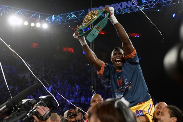 Jun 8, 2013; Montreal, Quebec, Canada; Adonis Stevenson (gold/yellow) celebrates with the belt after knocking out Chad Dawson (not pictured) during the first round of their light heavyweight  WBC title bout at the Bell Centre. Mandatory Credit: Eric Bolte-USA TODAY Sports