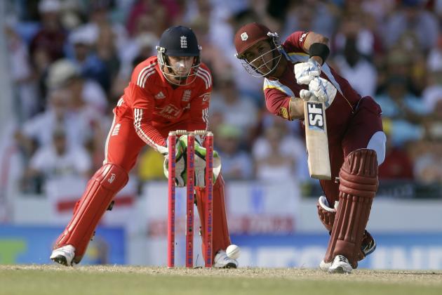 West Indies' Lendl Simmons plays a shot as England's wicket keeper Jos Buttler looks on during their third T20 International cricket match at the Kensington Oval in Bridgetown, Barbados, Thursday, March 13, 2014. (AP Photo/Ricardo Mazalan)