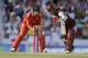 West Indies' Lendl Simmons plays a shot as England's wicket keeper Jos Buttler looks on during their third T20 International cricket match at the Kensington Oval in Bridgetown, Barbados, Thursday, March 13, 2014. (AP Photo/Ricardo Mazalan)