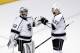 Los Angeles Kings defenseman Willie Mitchell (33) celebrates the Kings' 6-2 win over the Chicago Blackhawks with goalie Jonathan Quick (32) after Game 2 of the Western Conference finals in the NHL hockey Stanley Cup playoffs Wednesday, May 21, 2014, in Chicago. (AP Photo/Charles Rex Arbogast)