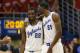 Kansas guard Andrew Wiggins (22) and center Joel Embiid (21) during the first half of an NCAA college basketball game against Oklahoma State at Allen Fieldhouse in Lawrence, Kan., Saturday, Jan. 18, 2014. (AP Photo/Orlin Wagner)