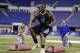 Minnesota defensive lineman Ra'Shede Hageman runs a drill at the NFL football scouting combine in Indianapolis, Monday, Feb. 24, 2014. (AP Photo/Michael Conroy)