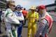 Helio Castroneves, of Brazil, right center, tells a story to fellow drivers Ed Carpenter, left, Ryan Briscoe, of Australia, left center, and Tony Kanaan, of Brazil, before the start of practice for the Indianapolis 500 IndyCar auto race at the Indianapolis Motor Speedway in Indianapolis, Monday, May 19, 2014. (AP Photo/Michael Conroy)
