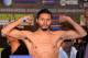 LOS ANGELES, CA - AUGUST 23: Jhonny Gonzalez poses as he steps on the scale at 125 pounds before his fight against Abner Mares during the weigh in at the Millennium Biltmore Hotel on August 23, 2013 in Los Angeles, California. (Photo by Harry How/Getty Images)