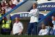 Chelsea manager Jose Mourinho smiles as he watches their English Premier League soccer match against Norwich City at Stamford Bridge stadium in London, Sunday May 4, 2014. (AP Photo/Alastair Grant)
