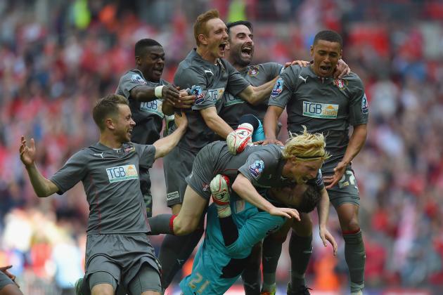 LONDON, ENGLAND - MAY 25:  Rotherham goalkeeper Adam Collin is mobbed by team mates after the penalty shoot out during the Sky Bet League One Playoff Final between Leyton Orient and Rotherham United at Wembley Stadium on May 25, 2014 in London, England.  (Photo by Mike Hewitt/Getty Images)