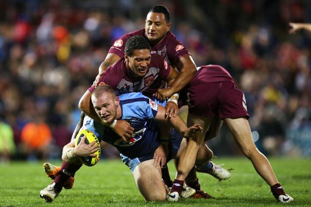 SYDNEY, AUSTRALIA - MAY 03:  Matt Lodge of the NSW is tackled by the QLD defence during the U20's State of Origin match between the New South Wales Blues and the Queensland Maroons at Sportingbet Stadium on May 3, 2014 in Sydney, Australia.  (Photo by Brendon Thorne/Getty Images)
