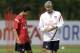 Arsenal's Cesc Fabregas, left, talks to his French manager Arsene Wenger at the start of a training session at the club's facilities in London Colney, England, Friday, Aug. 5, 2011. The new English Premier League season starts on August 13 and it has been another offseason of unsettling speculation for Arsenal about whether captain Cesc Fabregas will return to Barcelona. (AP Photo/Matt Dunham)