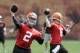 Cleveland Browns quarterback Johnny Manziel (2) passes with Brian Hoyer (6) during a practice at the NFL football team's facility in Berea, Ohio Wednesday, May 21, 2014. (AP Photo/Mark Duncan)